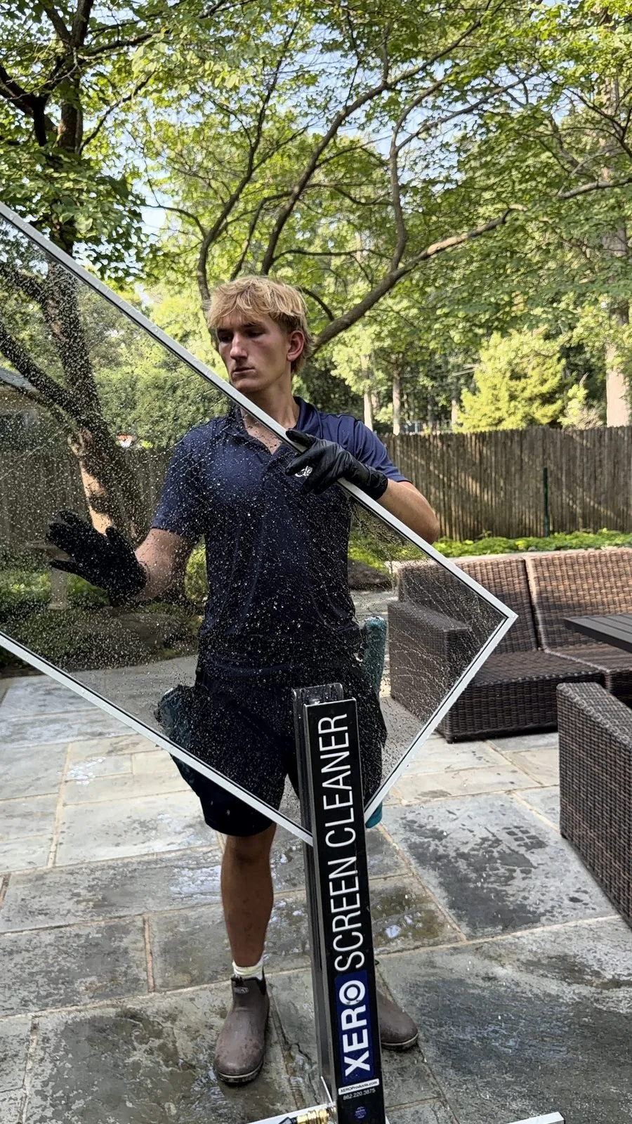 ClearDay technician washing a window screen for clearer views and airflow