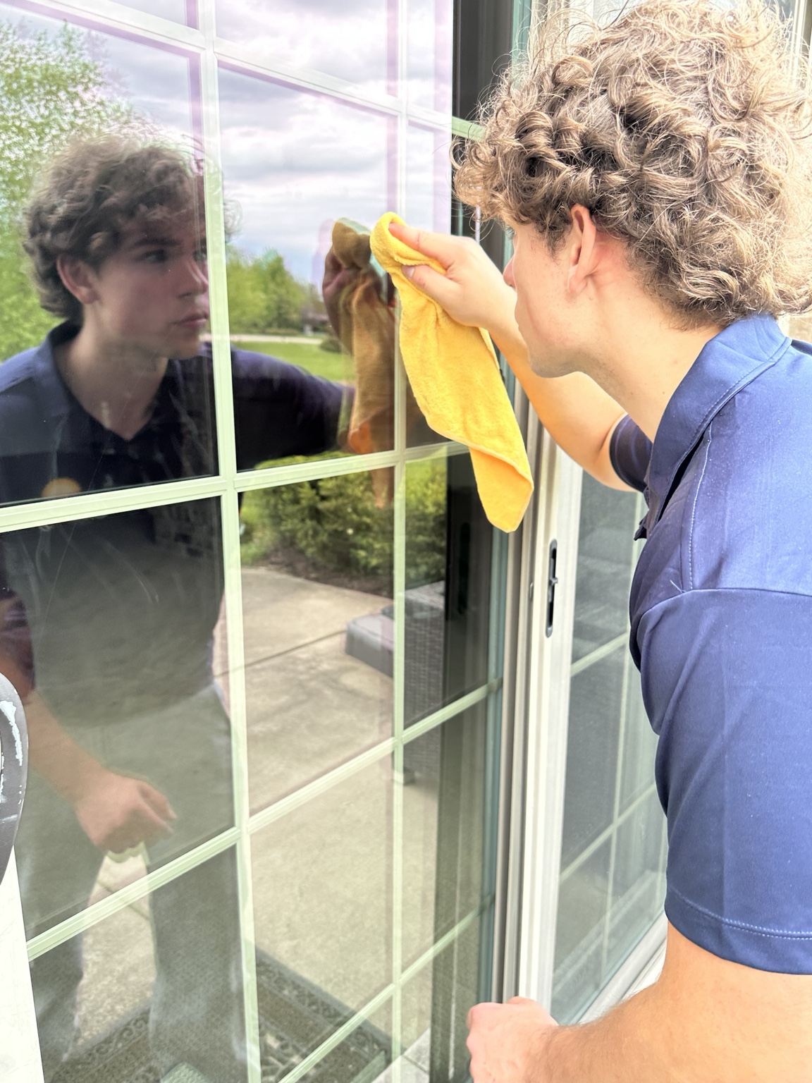 ClearDay technician detailing a window by hand